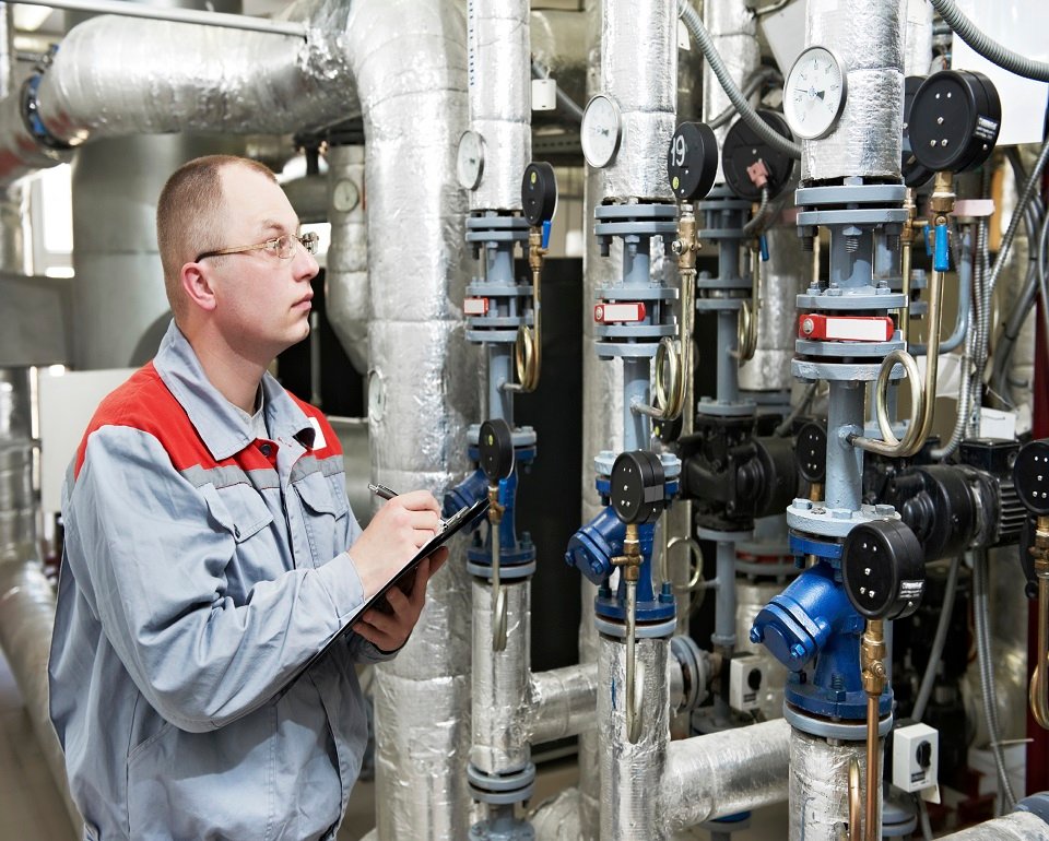 Heating engineer in boiler room