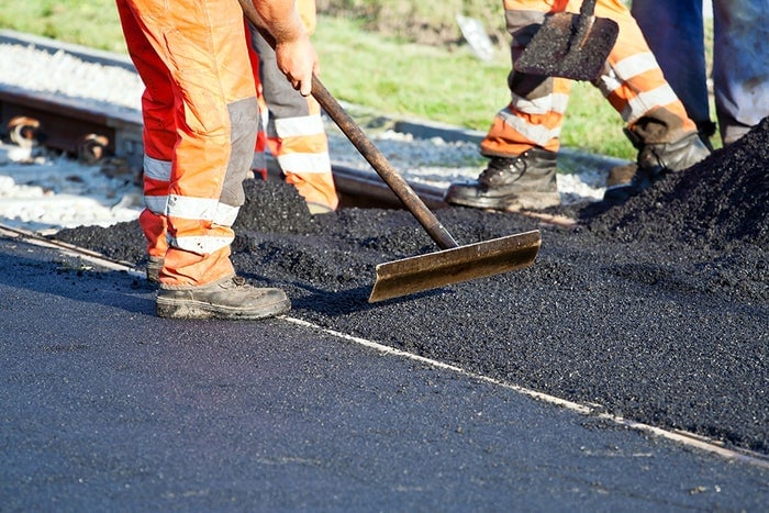 Roadworkers laying Kiwa tested asphalt